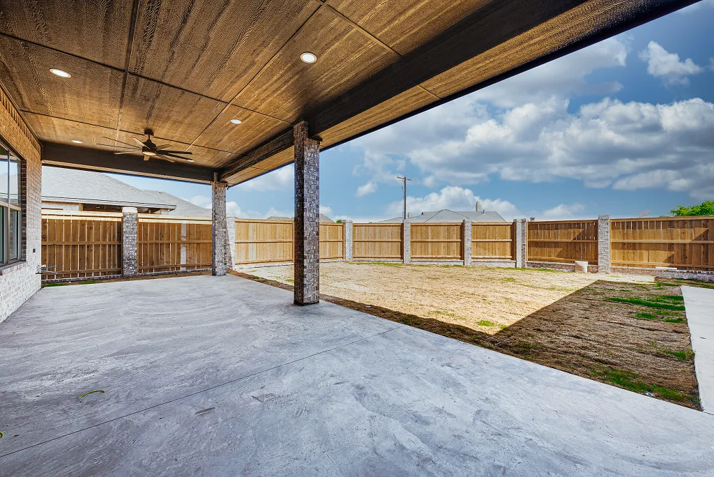 Covered back porch with ceiling fan and lighting at 119 Rolling Winds Circle Odessa TX