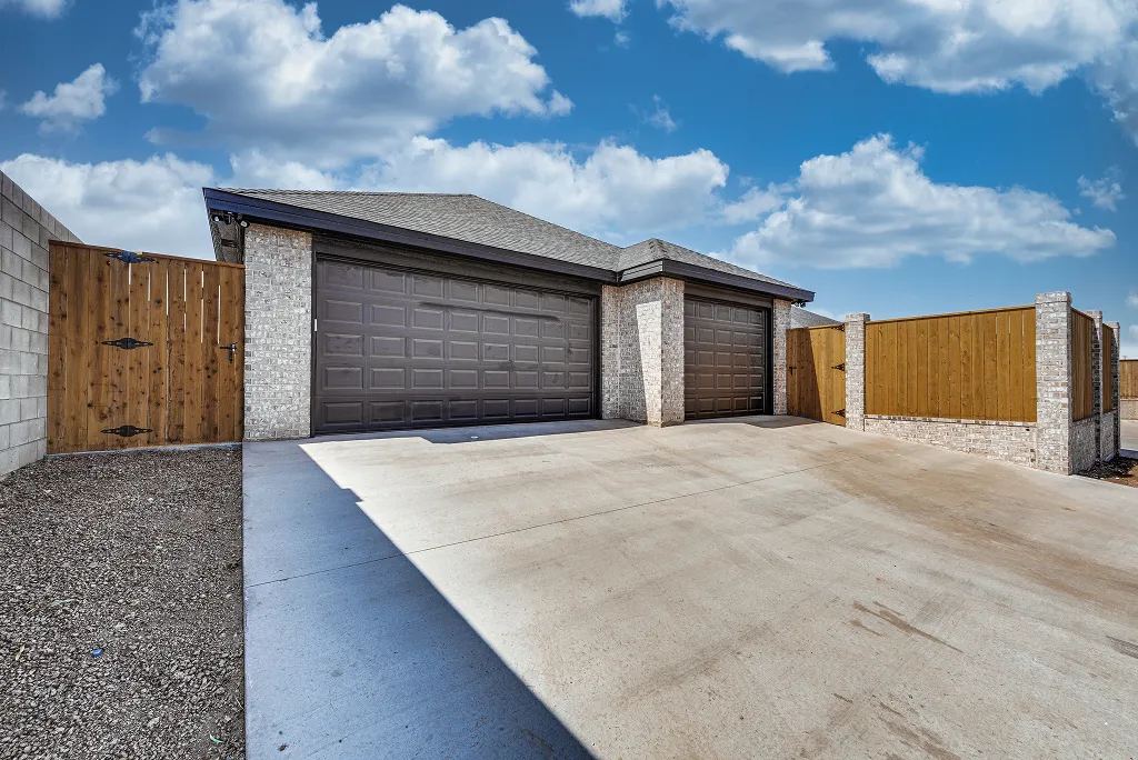 Full Rear view including 3-car garage and driveway at 119 Rolling Winds Circle Odessa TX