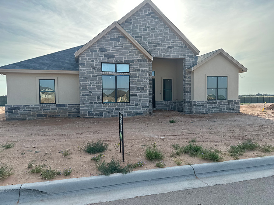 New suburban house with a stone facade. Midland, TX at The Vineyard